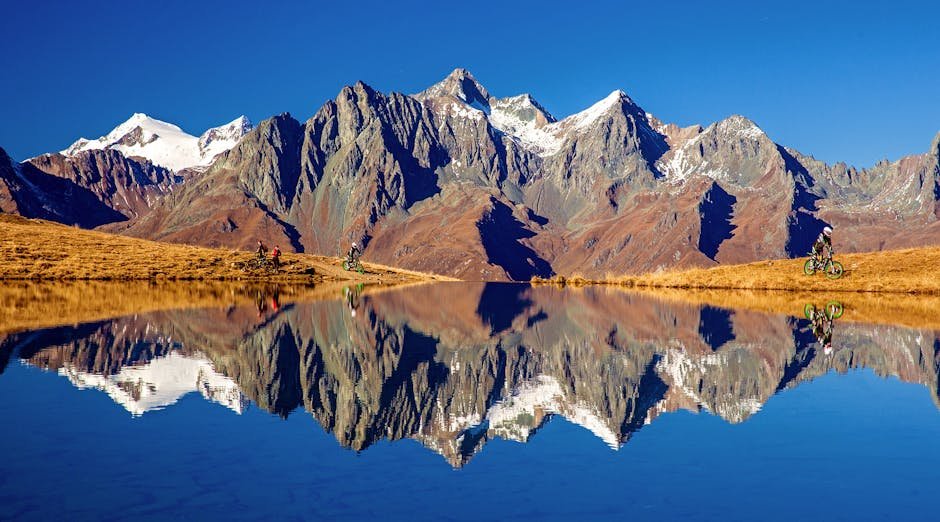 Majestic mountains reflected in Zupalsee with cyclists, Tirol, Austria.
